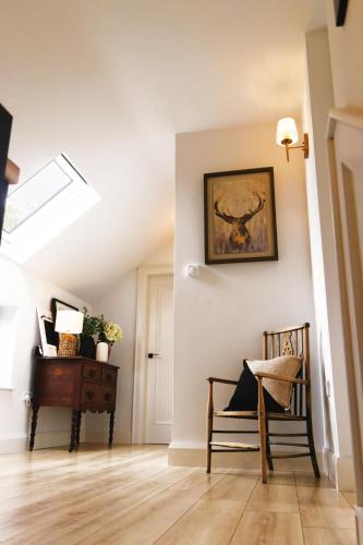 a room with a chair and a painting on the wall at Mary's Lane in Randalstown