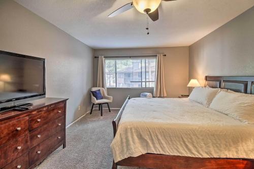 a bedroom with a bed and a flat screen tv at Convenient Pinetop Apt, 1-2 Mi To Golfing! in Indian Pine