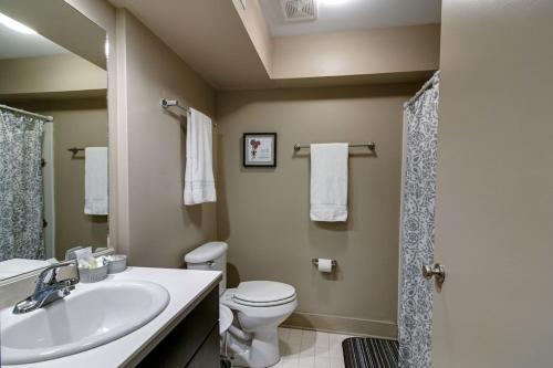 a bathroom with a sink and a toilet and a shower at The Lofts of Downtown (540 N 2nd St, #106) in Clarksville