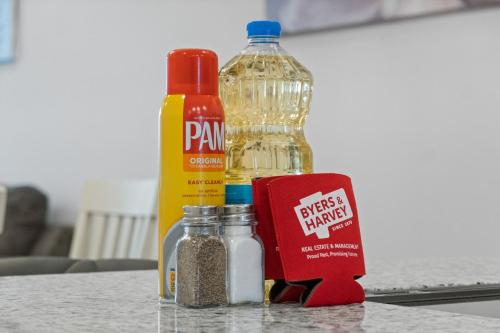 a table with a bottle of ketchup mustard and spices at Rebecca's Downtown Luxury Living (527 N 1st St, #C) in Clarksville