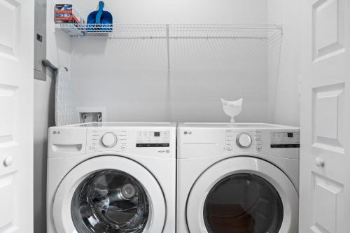a white washer and dryer in a white laundry room at Rebecca's Downtown Luxury Living (527 N 1st St, #C) in Clarksville