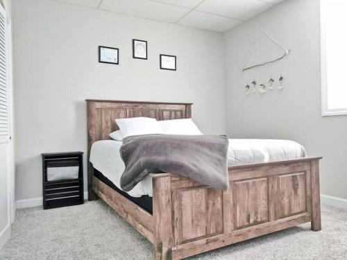 a bedroom with a wooden bed with a blanket on it at The Magnolia Suite At Hilltop Acres - Clarksville in Clarksville