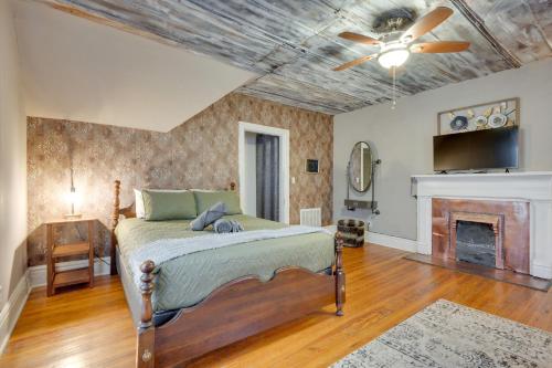 a bedroom with a bed and a fireplace at Historic Condo 2,5 Blocks From Fm Bank Arena in Clarksville