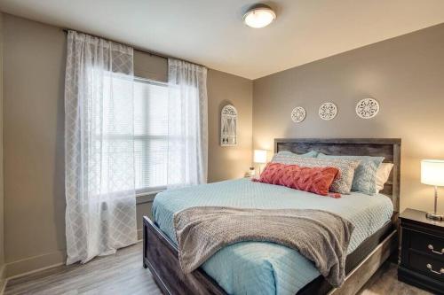 a bedroom with a large bed and a window at The Lofts 211 In Historic Downtown Clarksville in Clarksville