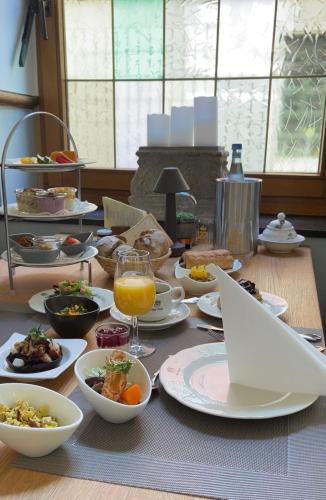 a table with food and a laptop on top of it at Das Hotel Krone in Königswinter