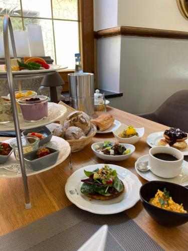 a table with many plates of food on it at Das Hotel Krone in Königswinter