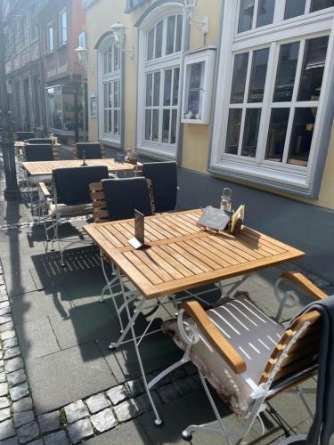 a row of wooden tables and chairs on a street at Das Hotel Krone in Königswinter
