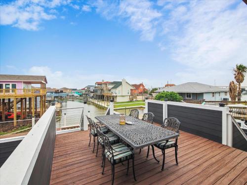 a patio with a table and chairs on a deck at Blue Fin in Freeport