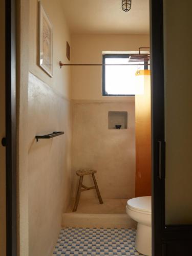 a bathroom with a toilet and a stool at DUNA by DW in San Juan