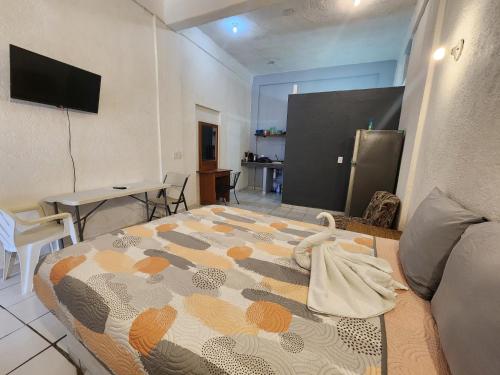 a bedroom with a bed with a towel on it at Small studio APT 5min to DT! in Zihuatanejo