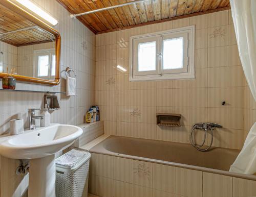 a bathroom with a sink and a bath tub at Eutuxia House in Corfu Town