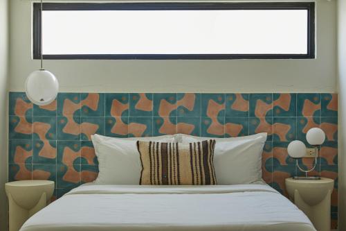 a bedroom with a bed and a window above it at DUNA by DW in San Juan