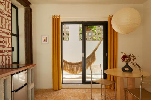 a kitchen with a table and a window with a net at DUNA by DW in San Juan