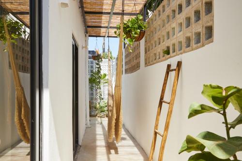 a corridor of a house with plants at DUNA by DW in San Juan