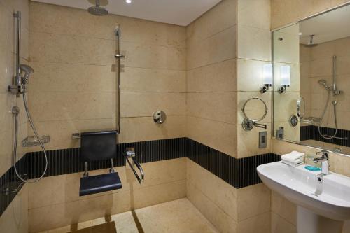 a bathroom with a shower and a sink at Le Meridien Cairo Airport in Cairo