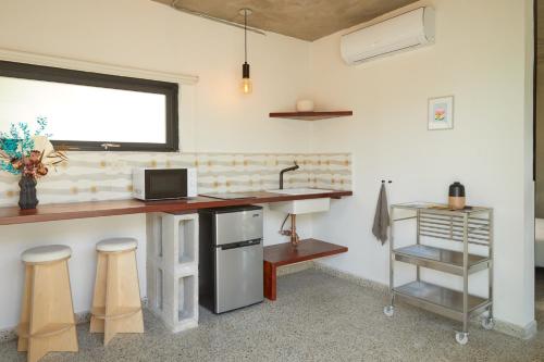 a kitchen with a sink and a counter with stools at DUNA by DW in San Juan