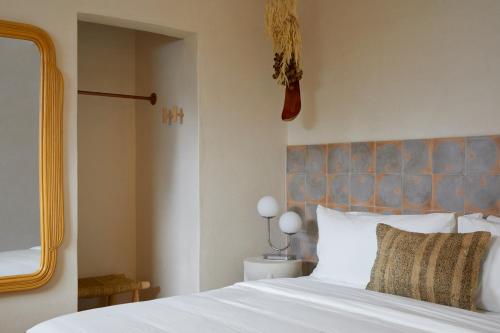 a bedroom with a white bed with a blue headboard at DUNA by DW in San Juan