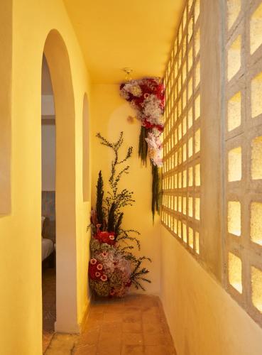 a hallway with a window and a vase of flowers at DUNA by DW in San Juan