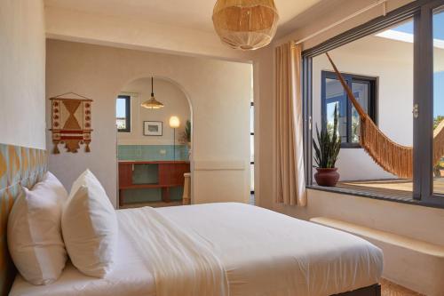 a bedroom with a white bed and a window at DUNA by DW in San Juan