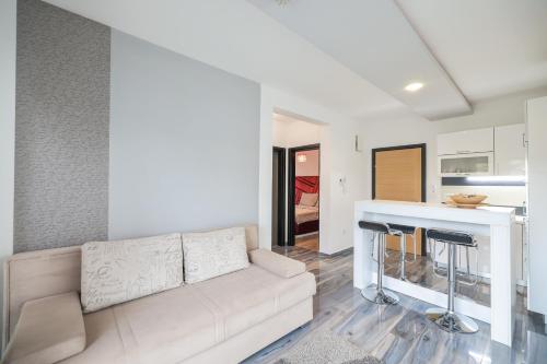 a living room with a couch and a kitchen at Boutique Apartments Blitz in Bibinje