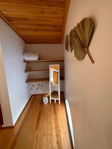 a room with a shelf and a clock on the wall at Hanole Guest House in Ayvalık