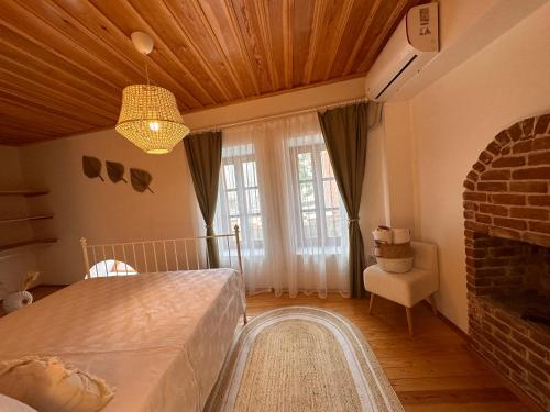 a bedroom with a bed and a fireplace at Hanole Guest House in Ayvalık