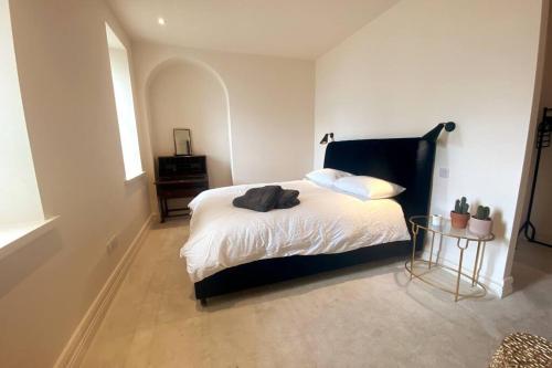 a bedroom with a bed and a table at Luxurious 2 bedroom apartment with sea view in Monkstown in Blackrock