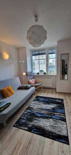 a living room with a couch and a rug at Sopot Baltic in Sopot
