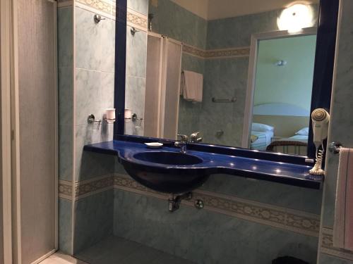 a bathroom with a sink and a mirror at Hotel Bristol - a 30 mt dalla spiaggia in Misano Adriatico