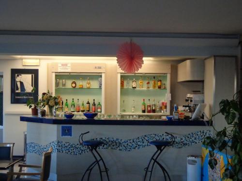 a bar in a restaurant with stools in front of it at Hotel Bristol - a 30 mt dalla spiaggia in Misano Adriatico
