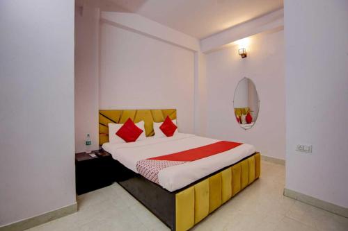 a bedroom with a large bed with red pillows at OYO Flagship Decent Residency in New Delhi