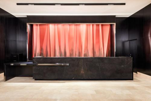 a stage with a red curtain in a room at AC Hotel by Marriott Santiago Cenco Costanera in Santiago