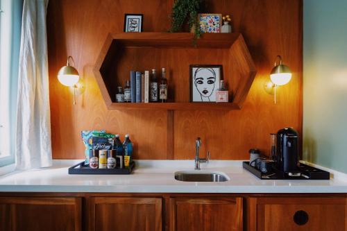 a kitchen counter with a sink and a coffee maker at Villa Royale in Palm Springs