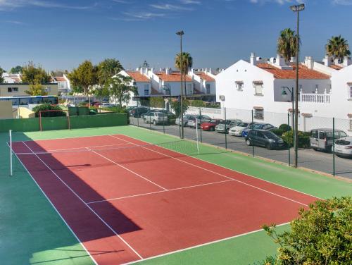 
a tennis court with a tennis racket on it at Sol Guadalmar in Málaga
