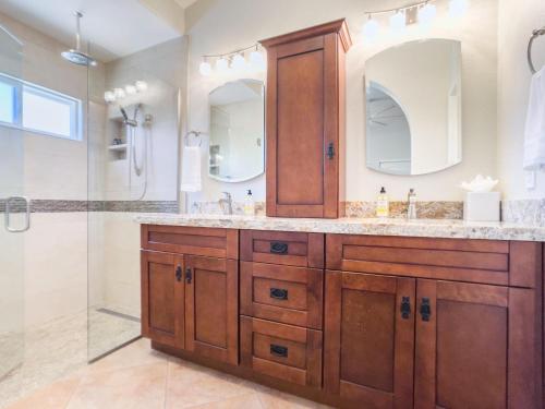 a bathroom with two sinks and a shower at Chandler Earhart in Chandler