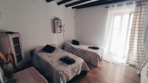 a bedroom with two beds and a large window at Apartament Picasso in Tarragona