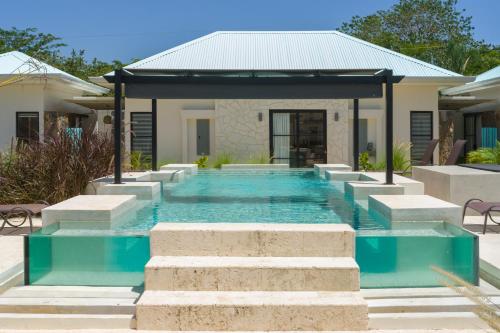 a swimming pool in the backyard of a house at Villas VR Beachwalk Avellanas in Playa Avellana