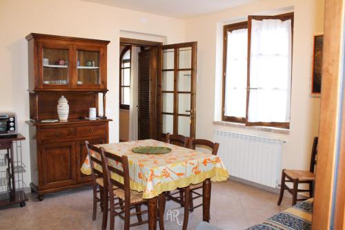 a dining room with a table and chairs and a window at PICCI HOUSE in Pomaia