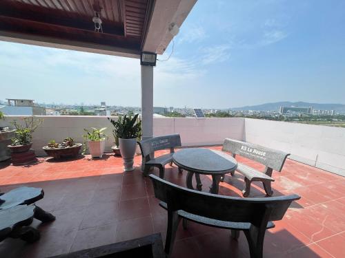 a patio with a table and chairs on a roof at Le House Hotel and Studio in Danang