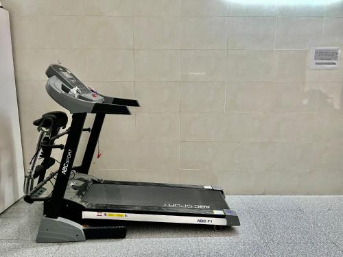 a treadmill is sitting on the floor next to a wall at Le House Hotel and Studio in Danang