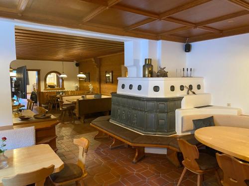 a restaurant with a stove in the middle of a room at Pension Baranekhof - accommodation in nature - Baranek Resorts in Kaprun