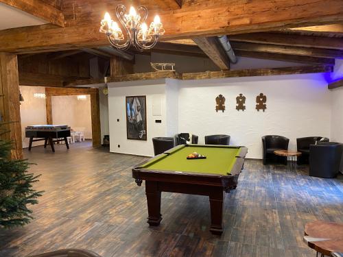 a pool table in a room with a ping pong ball at Pension Baranekhof - accommodation in nature - Baranek Resorts in Kaprun