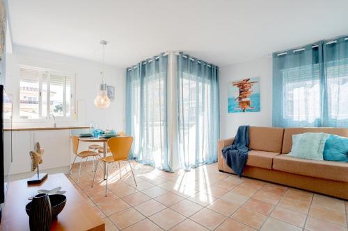 a living room with a couch and a table at Apartamentos Turisticos CAN CUNILL in Es Pujols