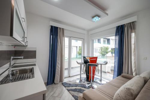 a living room with a couch and a table at Boutique Apartments Ad Astra in Bibinje