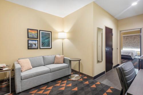 a living room with a couch and a table at Holiday Inn Hotel & Suites Waco Northwest by IHG in Bellmead