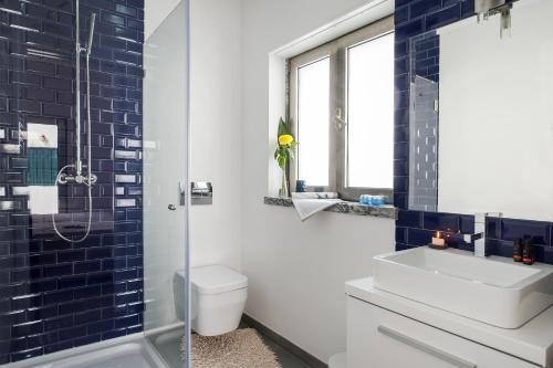 a bathroom with a toilet and a sink and a shower at Beachouse - Surf, Bed & Breakfast in Ericeira
