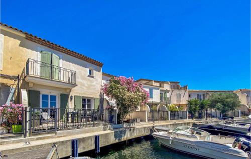 a boat is docked in a canal with buildings at Cozy Home In Aigues-Mortes With Wifi in Aigues-Mortes