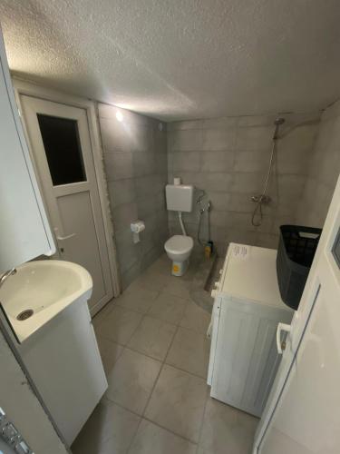 a small bathroom with a toilet and a sink at Golden Dream in Jajce