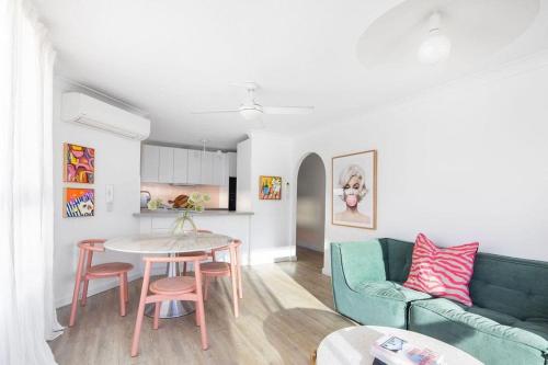 a living room with a couch and a table at Blush on Broadbeach- beachside and pet friendly, 3rd floor walk up in Gold Coast