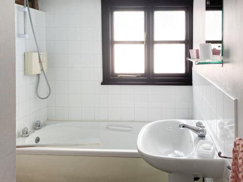 a white bathroom with a tub and a sink at Easterley Uk31585 in Clifford